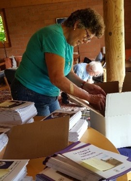 Heidi Bodmer packing the booklets for shipping