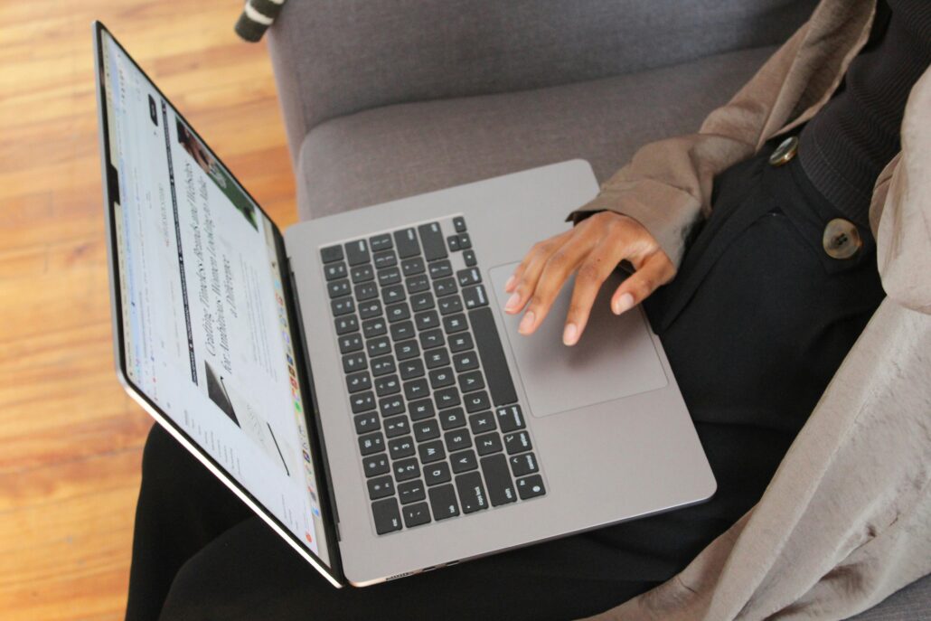 Woman conducting feminist work with a laptop on her lap