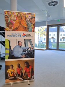 The image provided displays a promotional banner for UN Women, the United Nations entity dedicated to gender equality and the empowerment of women and girls. The banner uses the slogan and campaign title "For ALL Women and Girls". The banner features three distinct images of women and girls from various cultural backgrounds and professions, illustrating the organization's global focus on women's rights and empowerment in different areas of life, such as economic empowerment (the woman in the bus/truck), and community engagement. The "For ALL Women and Girls" campaign is a global initiative by UN Women that calls for action to accelerate progress on gender equality, focusing on rights, equality, and empowerment, particularly in areas like freedom from violence, economic security, and equal decision-making power.